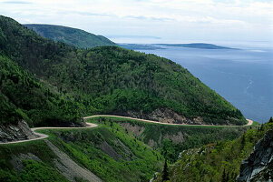 Cabot Trail winding along the coast in Cape Breton Highlands National Park, Nova Scotia, Canada; Cape Breton Island, Nova Scotia, Canada