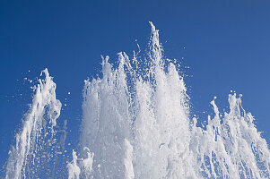Water fountain splashes against a blue sky, Amaliehaven Park; Copenhagen, Denmark