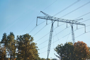 Low angle view of electricity pylon against blue sky