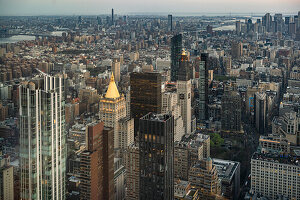 Aerial view of buildings against sky in city during sunset