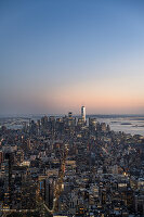 Aerial view of cityscape with modern buildings during sunset