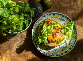 Roll with figs, avocado, and lettuce leaves