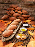 Raw sweet potatoes with spices and oil