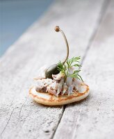 Mini blini with potted mackerel and capers