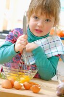 Young girl beating eggs