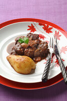 Bourguignon with peppery chocolate sauce and roasted pears