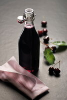 Homemade cherry juice in a swing-top bottle