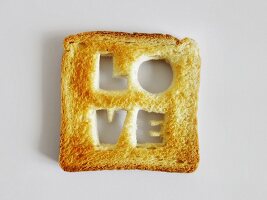 The word "Love" cut out of a slice of toast