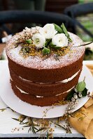 Cocoa and raspberry Naked cake decorated with flowers