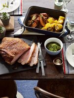 Roasted pork shoulder with salsa verde and roast vegetables