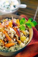Spicy bulgur with roasted vegetables, raisins and almonds