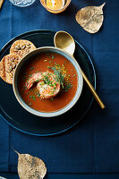 Spicy soup with a jumbo shrimp,seedy crackers