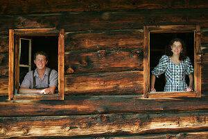 Young couple looking throw window