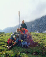 Family on a summit, Eng, Kleiner Ahornboden, Tyrol, Austria