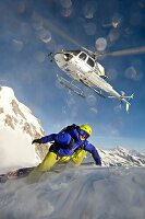 Helicopter and skier in the mountains, South Tyrol, Italy, Europe