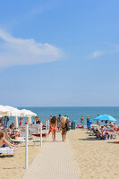 Holiday makers on the beach, Jesolo, Veneto, Adriatic, Italy