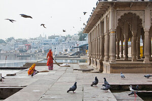 Two women sweeping the floor near a Ghat, Pushkar, Rajasthan, India