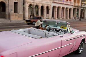 Pink oldtimer, cabriolet, driving along Malecon, taxi, historic town, center, old town, Habana Vieja, Habana Centro, family travel to Cuba, holiday, time-out, adventure, Havana, Cuba, Caribbean island