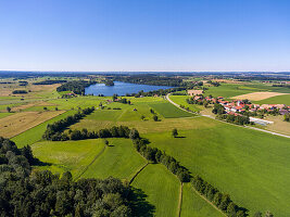 Bird's eye view over a forest on hair moss, Abbot Villages Lake and abbot's village in the Berchtesgadener Land