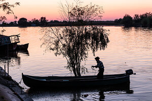 A fisherman in the Danube Delta casts at dusk, Mila 23, Tulcea, Romania.