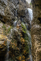 Waterfall over the rock face in the Höllentalklamm, Grainau, Upper Bavaria, Germany