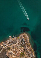  Boat and part of the island in the sea from above 