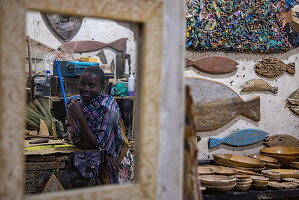 Reflection of a young woman in a craft shop, Lamu, Lamu Island, Kenya, Africa 