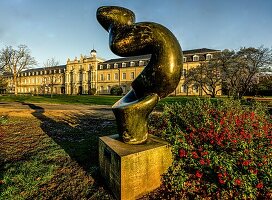 Sculpture in the Hofgarten with a view of the Electoral Palace in spring, Bonn, NRW, Germany 