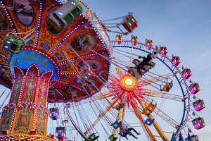  View of a carousel and the Ferris wheel, folk festival, Theresienwiese, Munich, Bavaria, Germany 