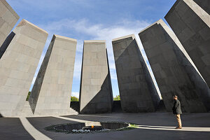 moment of reverence in front of the eternal flame at the center of the twelve granite slabs of the Armenian Genocide memorial complex on the hill of Tsitsernakaberd at Yerevan, Armenia, Eurasia