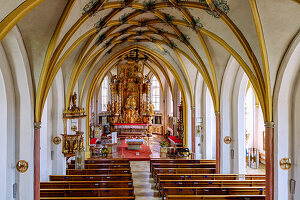  Interior of the fortified church Kößlarn (parish church of the Holy Trinity) with painted net vault and high altar with miraculous image in Markt Kößlarn in Lower Bavaria in Germany 