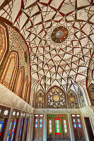 Richly decorated domed ceiling in one of the halls of the Tabatabaei House, a historic mansion built around 1880 in Kashan, Iran.