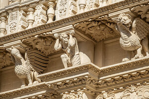 Detail of the richly decorated façade of the Basilica di Santa Croce in Lecce, Puglia, Italy.