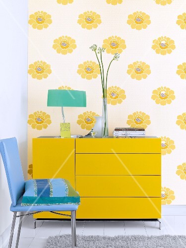 Yellow Dresser With Drawers In Front Of Wallpaper With Yellow