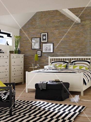 White Double Bed And Chests Of Drawers In Bedroom With Stone