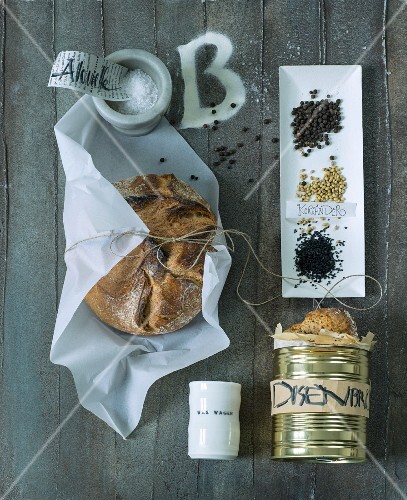 A loaf of bread, canned bread and various spices