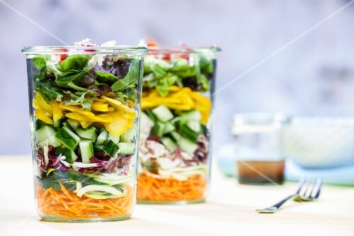 A layered vegetable salad in a glass